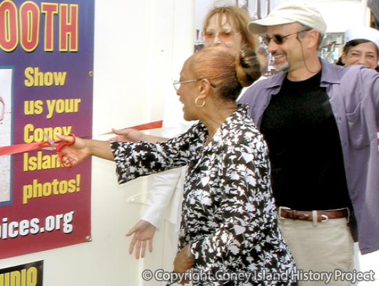 Margaret Williams (with Charles Denson and Carol Albert) cutting the ribbon at the dedication of the History Project Memory Booth in 2005.