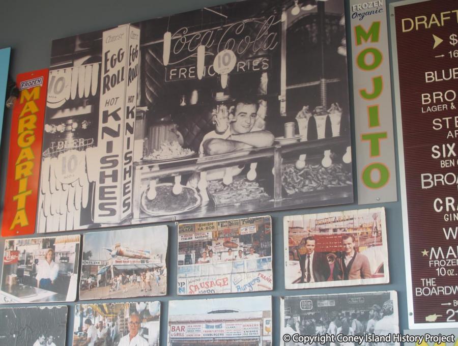 Vintage photos including one of Paul Georgoulakos at his first food stand in Coney Island behind the bar at Paul's Daughter, 2017. Photo © Coney Island History Project.