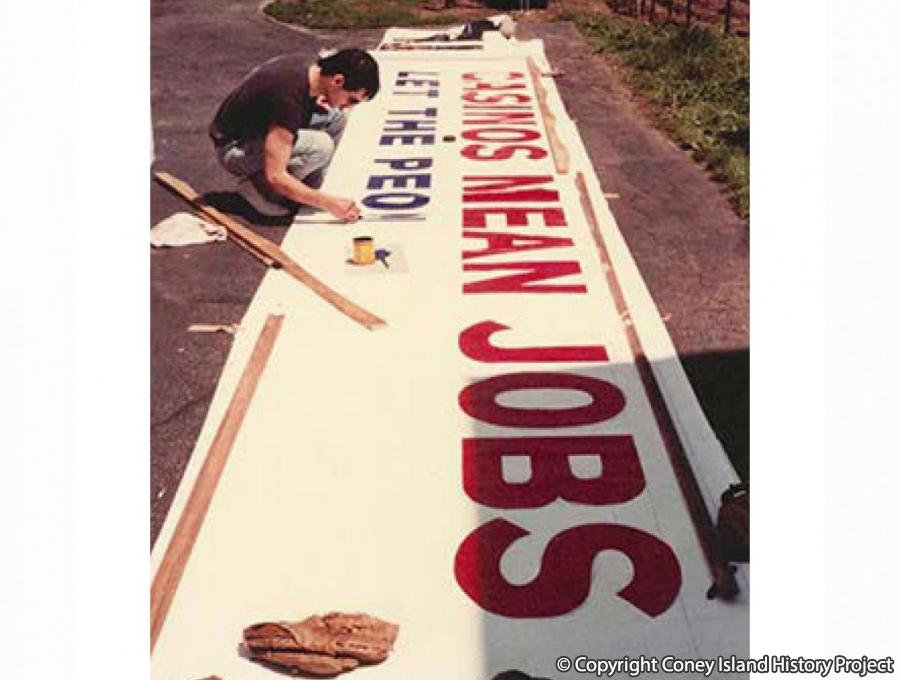 John Rea painting a "Casinos Mean Jobs - Let the People Decide" sign for Astroland in 1978. Photo © John Rea