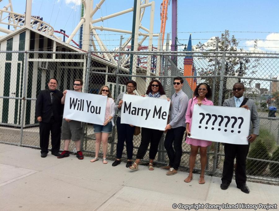 Max's friends holding up Will You Marry Me??? signs. Photo: Coney Island History Project Collection.